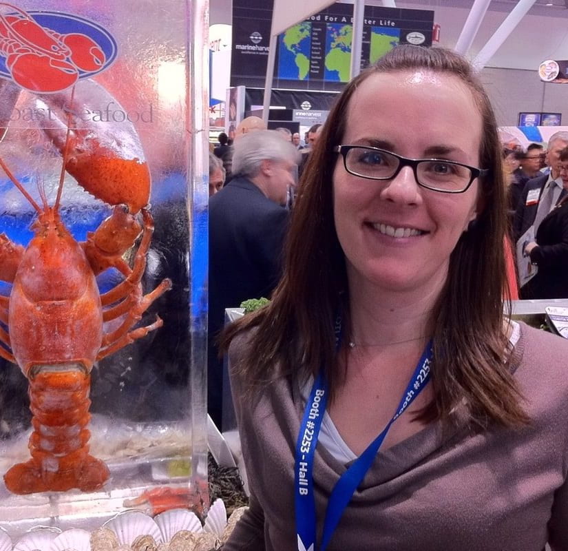 Dr. Silver next to a lobster in a tank