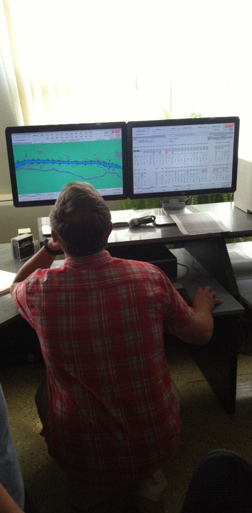 Two monitors showing dam operations in real-time